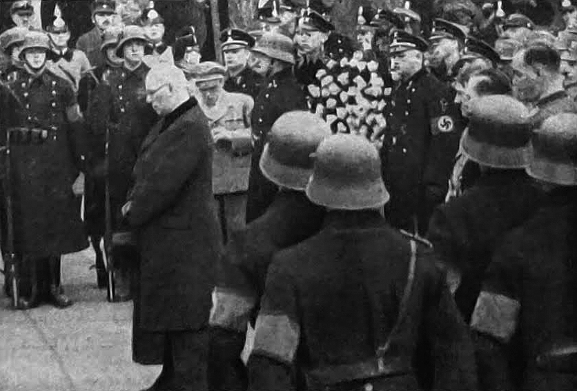 Adolf Hitler at the funeral of Paul Troost, pictured is Paul Troost's brother in front of the grave